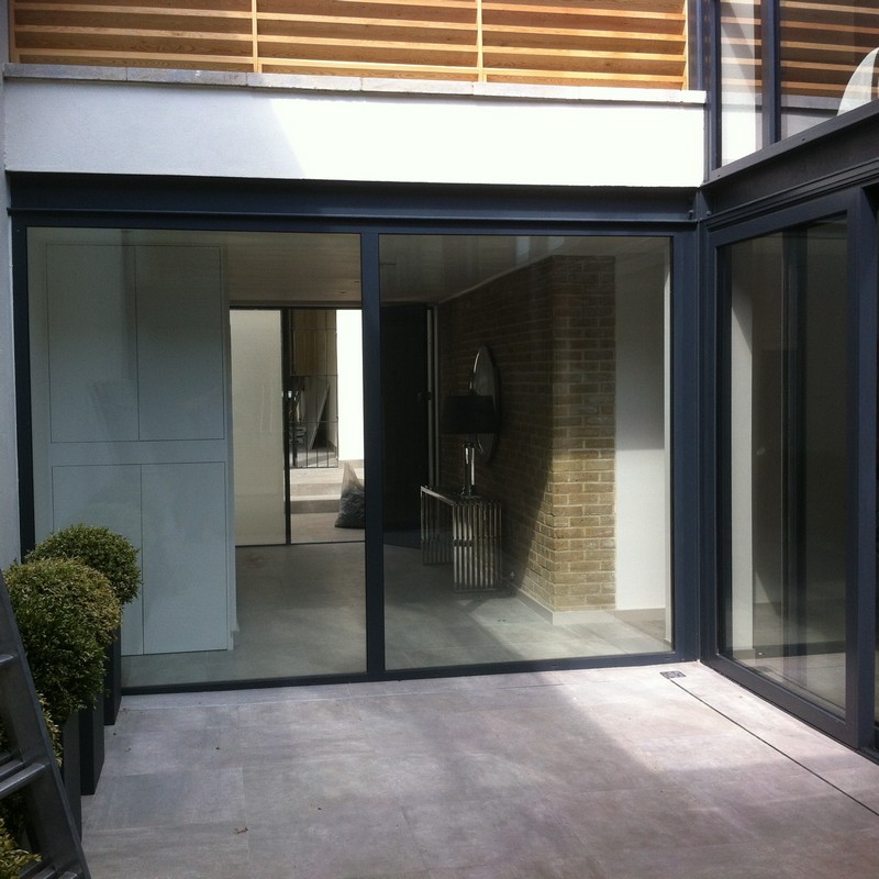 Floor-to-ceiling sliding doors opening to courtyard in Bethnal Green