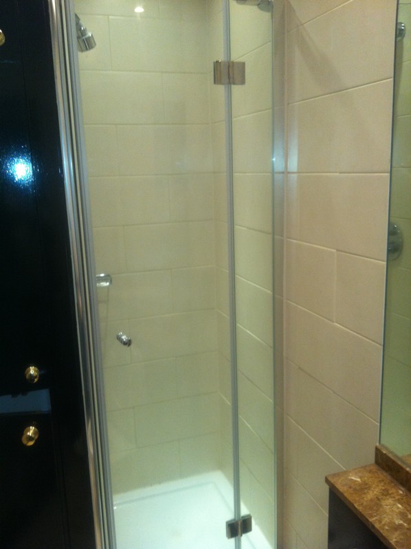 Frameless glass shower enclosure with chrome fittings in Bethnal Green