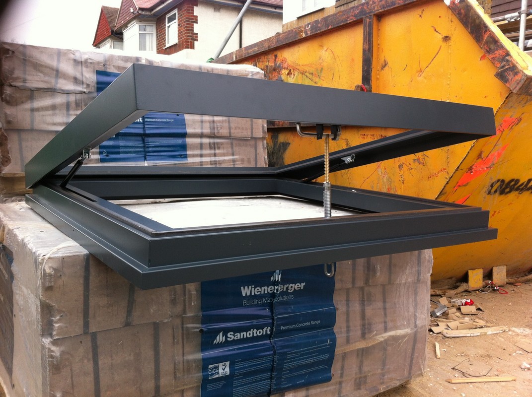 Opening flat roof skylight in anthracite grey installed in Bethnal Green