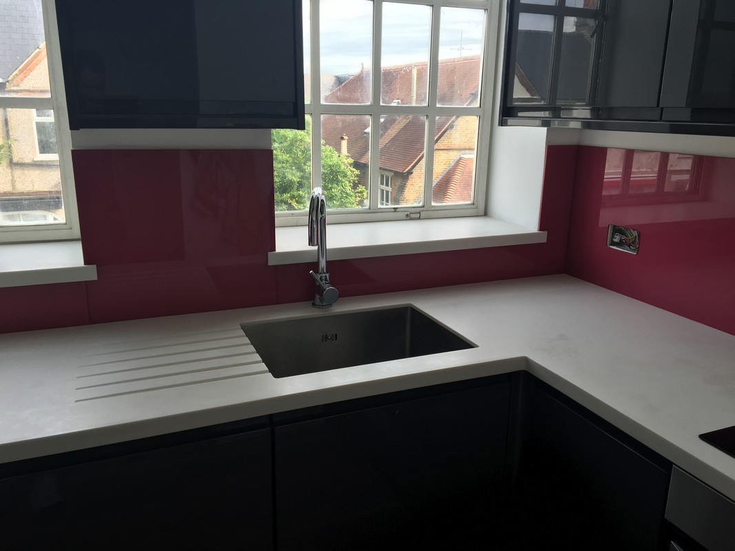 Deep plum coloured glass splashback in modern Bethnal Green kitchen