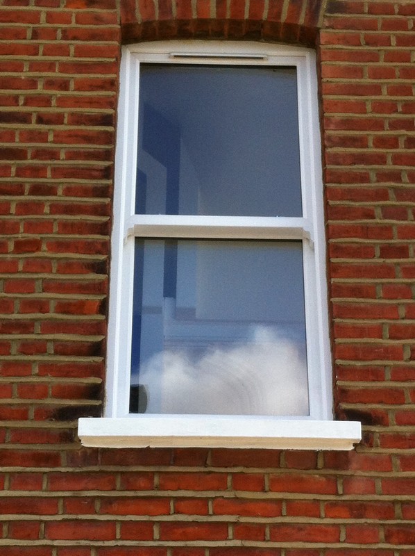 uPVC sash window on Victorian red brick house in Bethnal Green